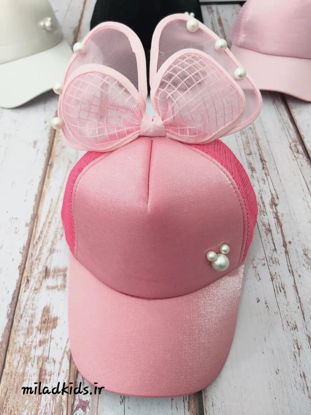 نمای روبرو کلاه کپ دخترانه پاپیون دار پشت توری رنگ صورتی پررنگ